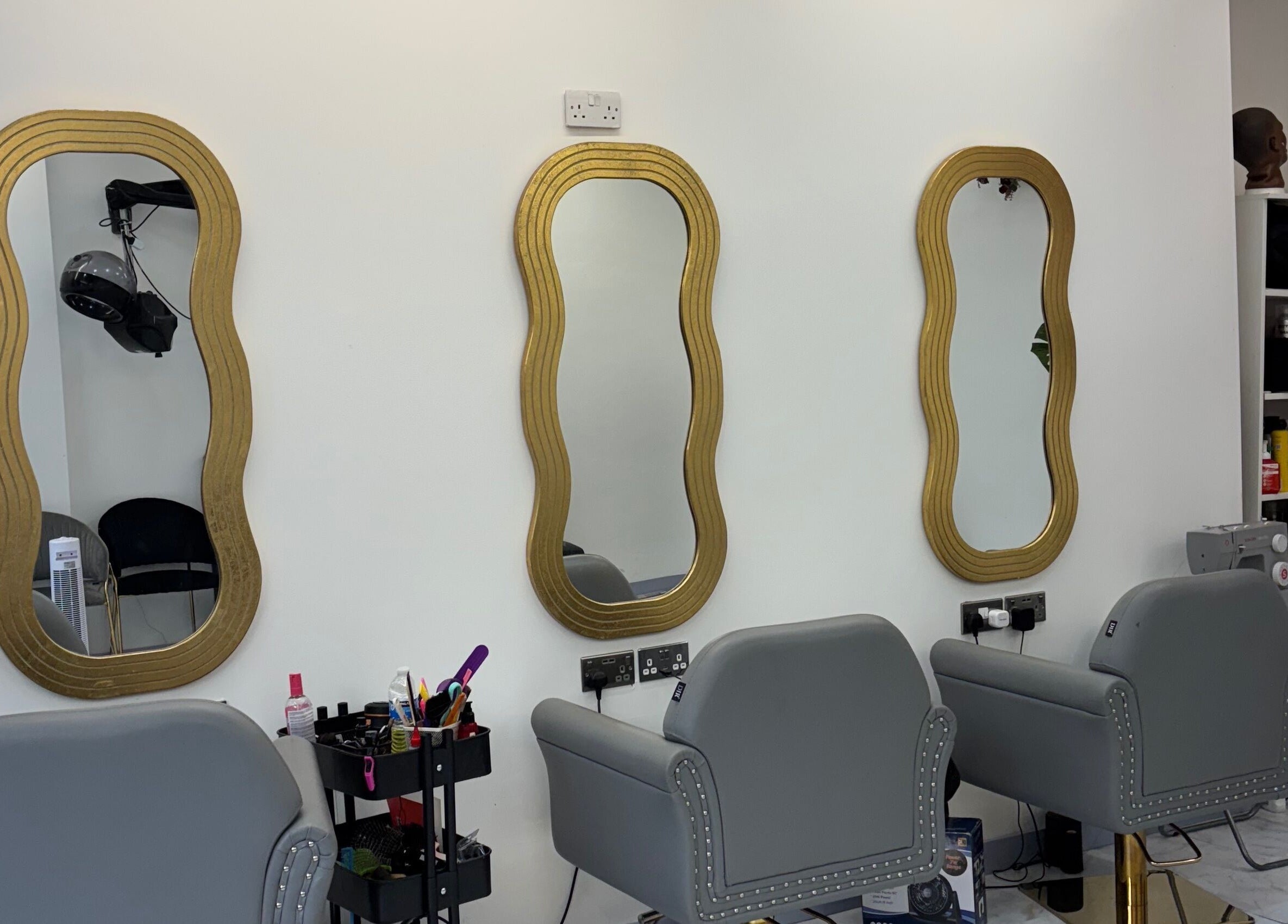 Elegant hairdressing mirrors at Hair Palace LDN in Peckham rye, England, GB. Chic salon decor and styling chairs.