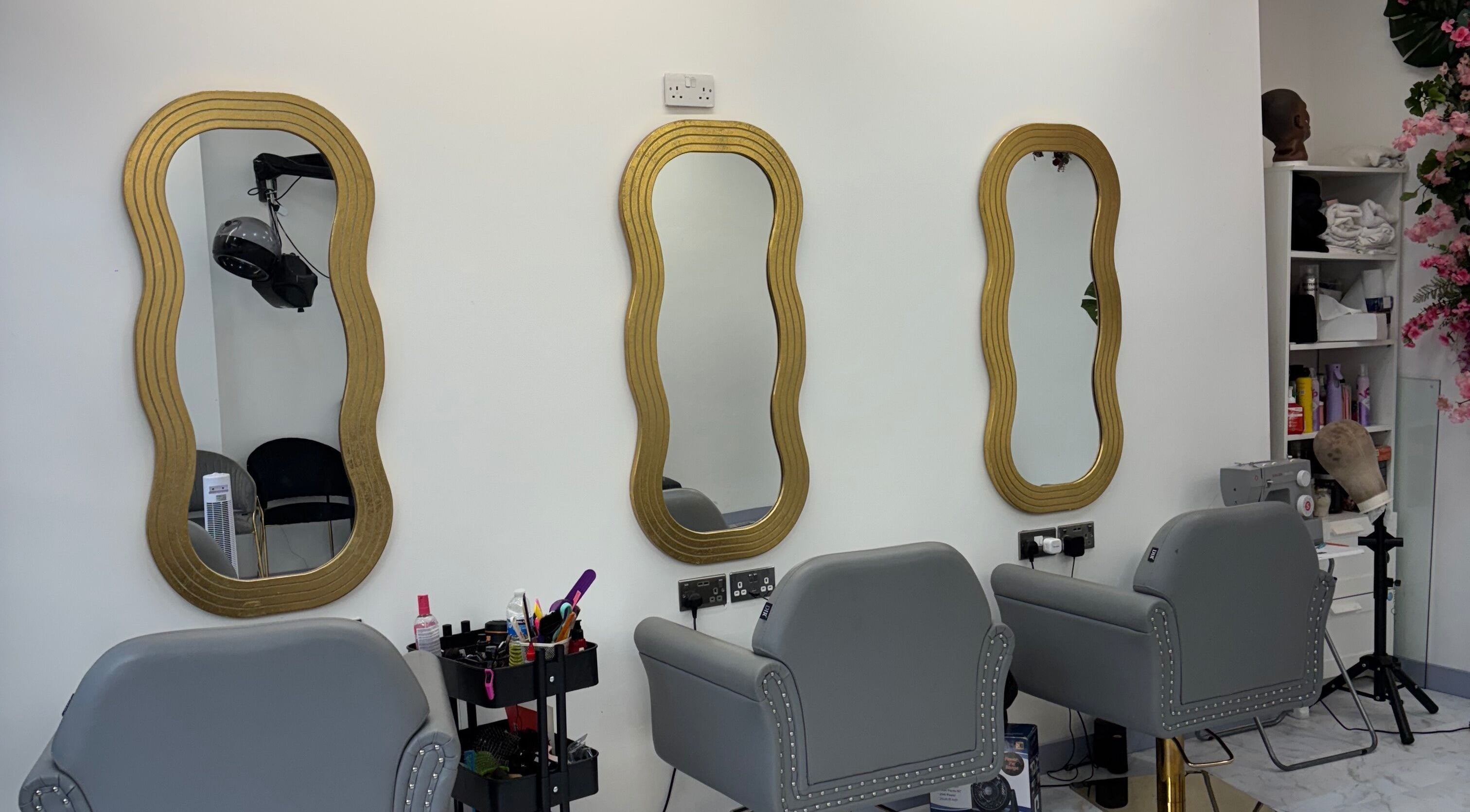 Elegant hairdressing mirrors at Hair Palace LDN in Peckham rye, England, GB. Chic salon decor and styling chairs.