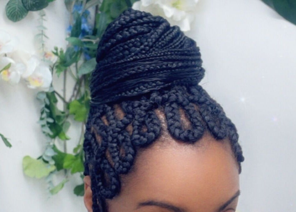 Elegant braided hairstyle from Hair Palace LDN, Peckham rye, England, GB, with lush plant backdrop.