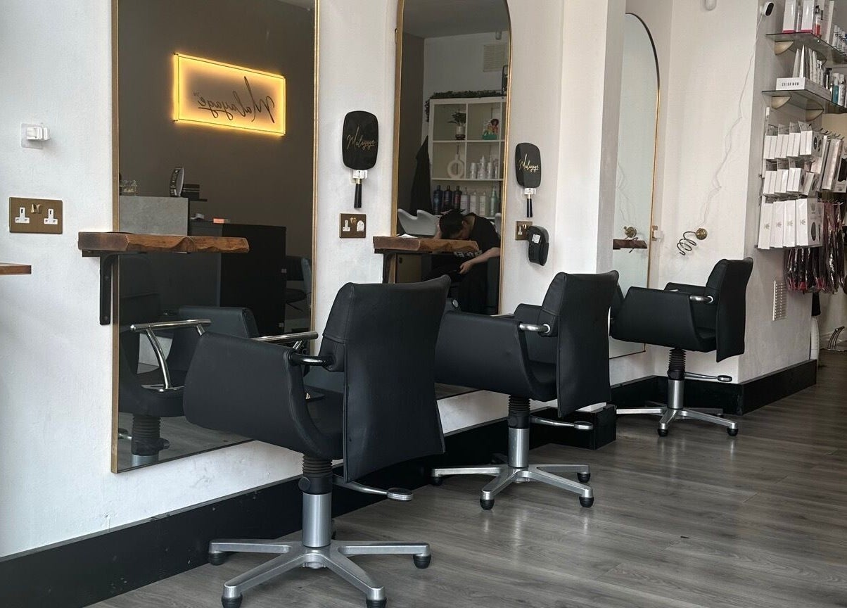 Modern salon chairs and mirrors at Malayage in Nottingham, England, GB, showcasing chic interior design.