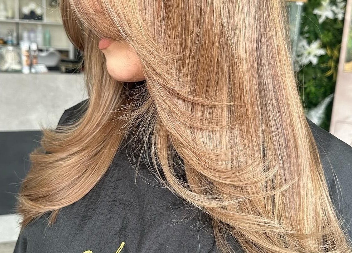 Smooth brunette hairstyle at Malayage, Nottingham, England, GB, showcasing expert salon styling.