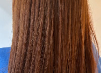 Sleek brown hair smoothly styled at Narimane Kanaan, Ottawa, Ontario, CA, showcasing vibrant hair treatment.
