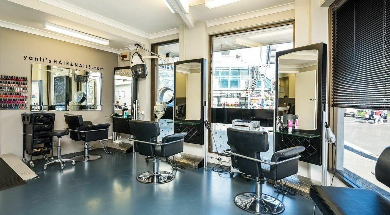 Modern interior of Yantis Hair and Nails in Maroubra, New South Wales, AU with sleek styling chairs and mirrors.