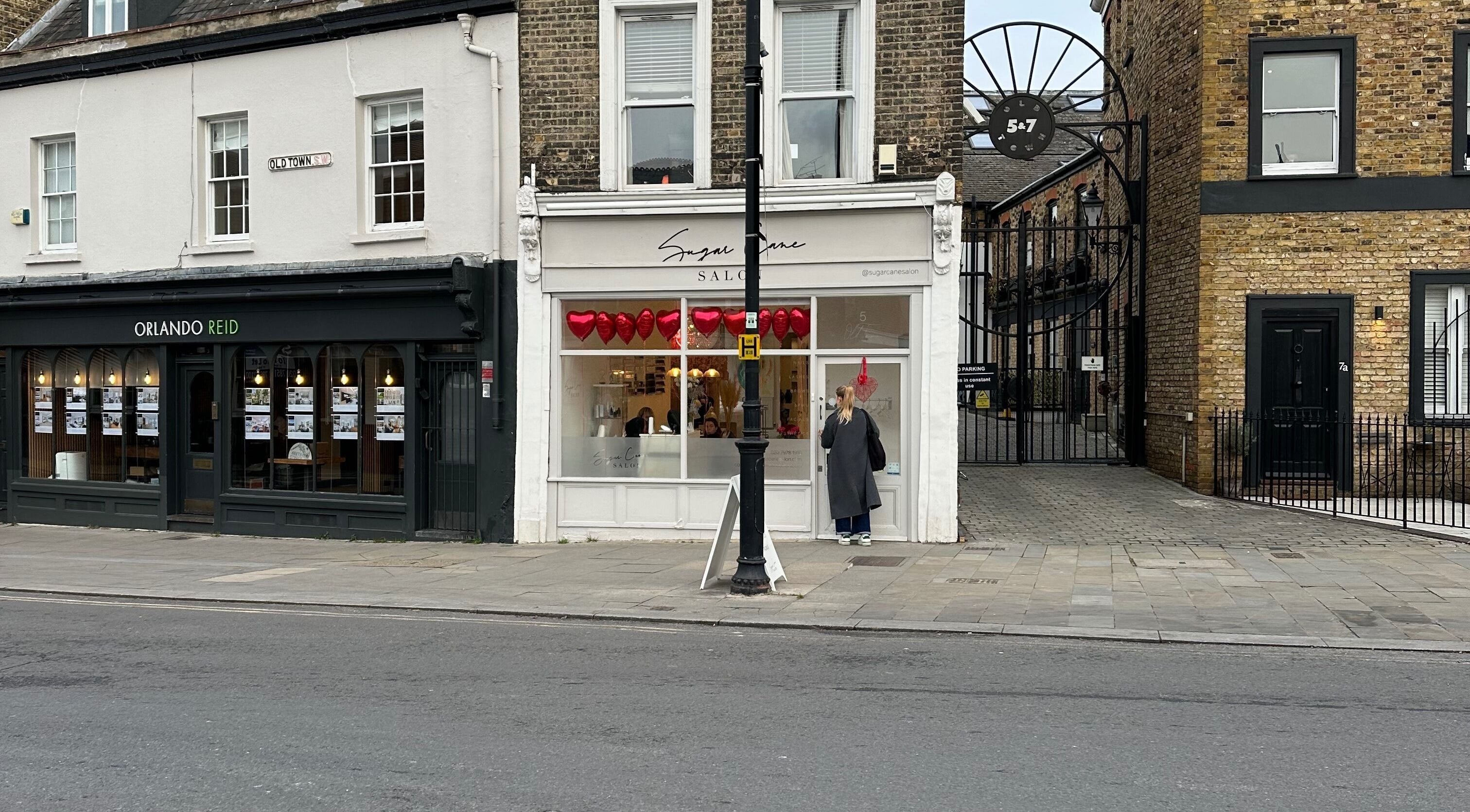 Street view of Sugar Cane Salon in London, England, GB, featuring heart decorations.