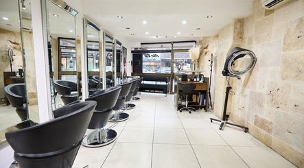 Sleek interior of Alter Ego Hair Design & Cosmetics, Rose Bay, New South Wales, AU showcasing modern styling chairs.