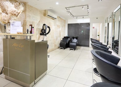 Chic and modern interior of Alter Ego Hair Design & Cosmetics in Rose Bay, New South Wales, AU with sleek chairs.