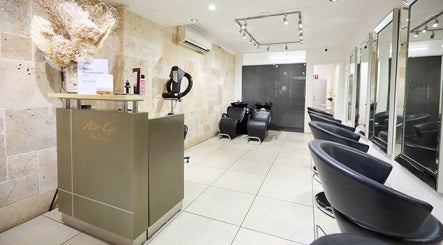 Chic and modern interior of Alter Ego Hair Design & Cosmetics in Rose Bay, New South Wales, AU with sleek chairs.