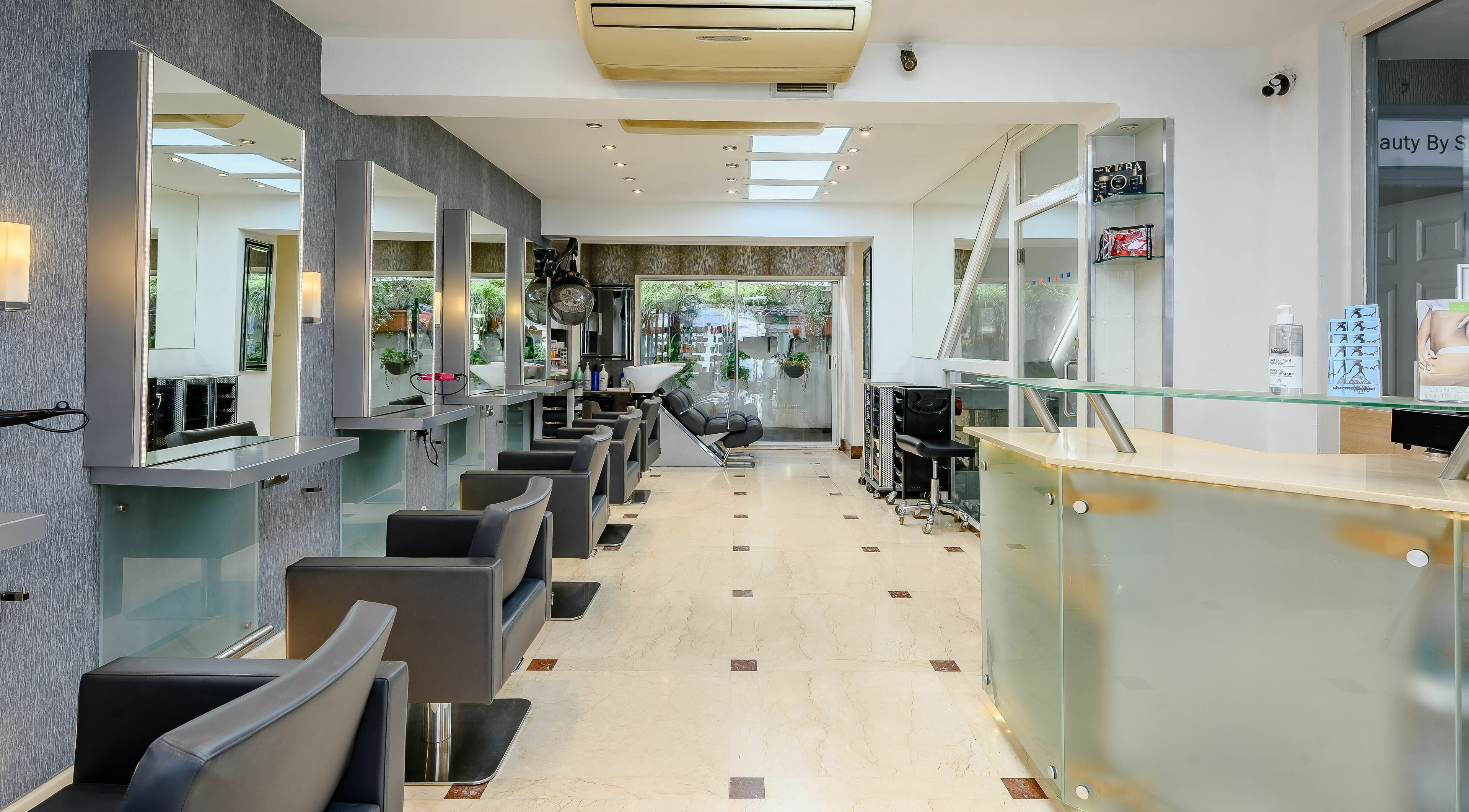 Sleek interior of Joseph Hair London salon, featuring modern chairs and mirrors in London, England, GB.