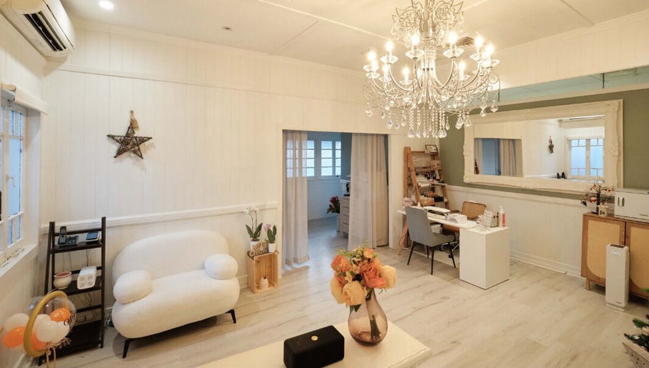 Elegant interior of Adore Beauty And Wellness, Hawthorne, Queensland, AU, showcasing a chandelier and cozy seating.