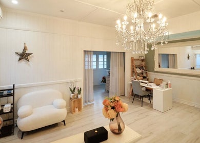 Elegant interior of Adore Beauty And Wellness, Hawthorne, Queensland, AU, showcasing a chandelier and cozy seating.
