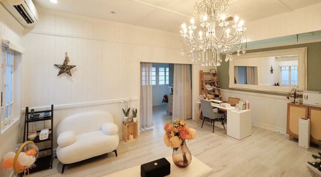 Elegant interior of Adore Beauty And Wellness, Hawthorne, Queensland, AU, showcasing a chandelier and cozy seating.