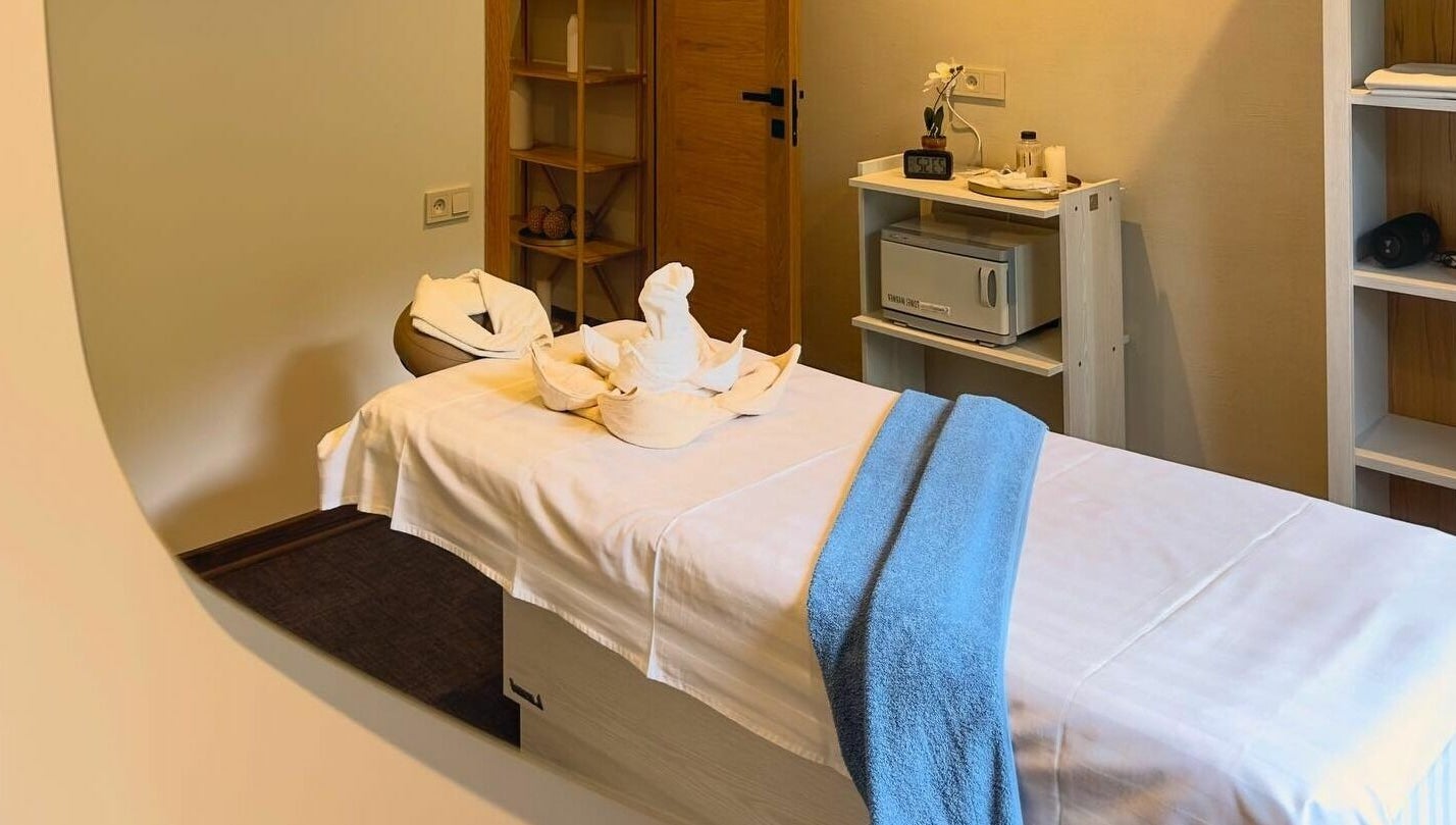 Tranquil massage room at Apricot Spa, Yerevan, AM, featuring a cozy bed with decorative towels.