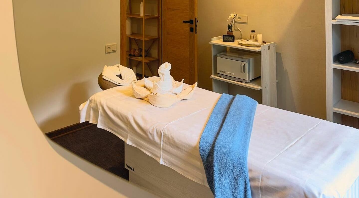 Tranquil massage room at Apricot Spa, Yerevan, AM, featuring a cozy bed with decorative towels.