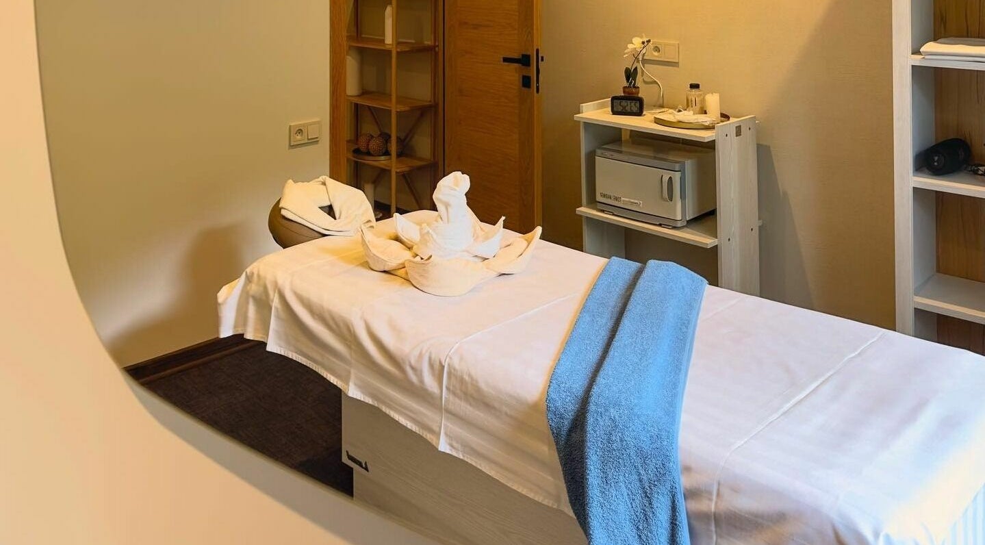 Tranquil massage room at Apricot Spa, Yerevan, AM, featuring a cozy bed with decorative towels.