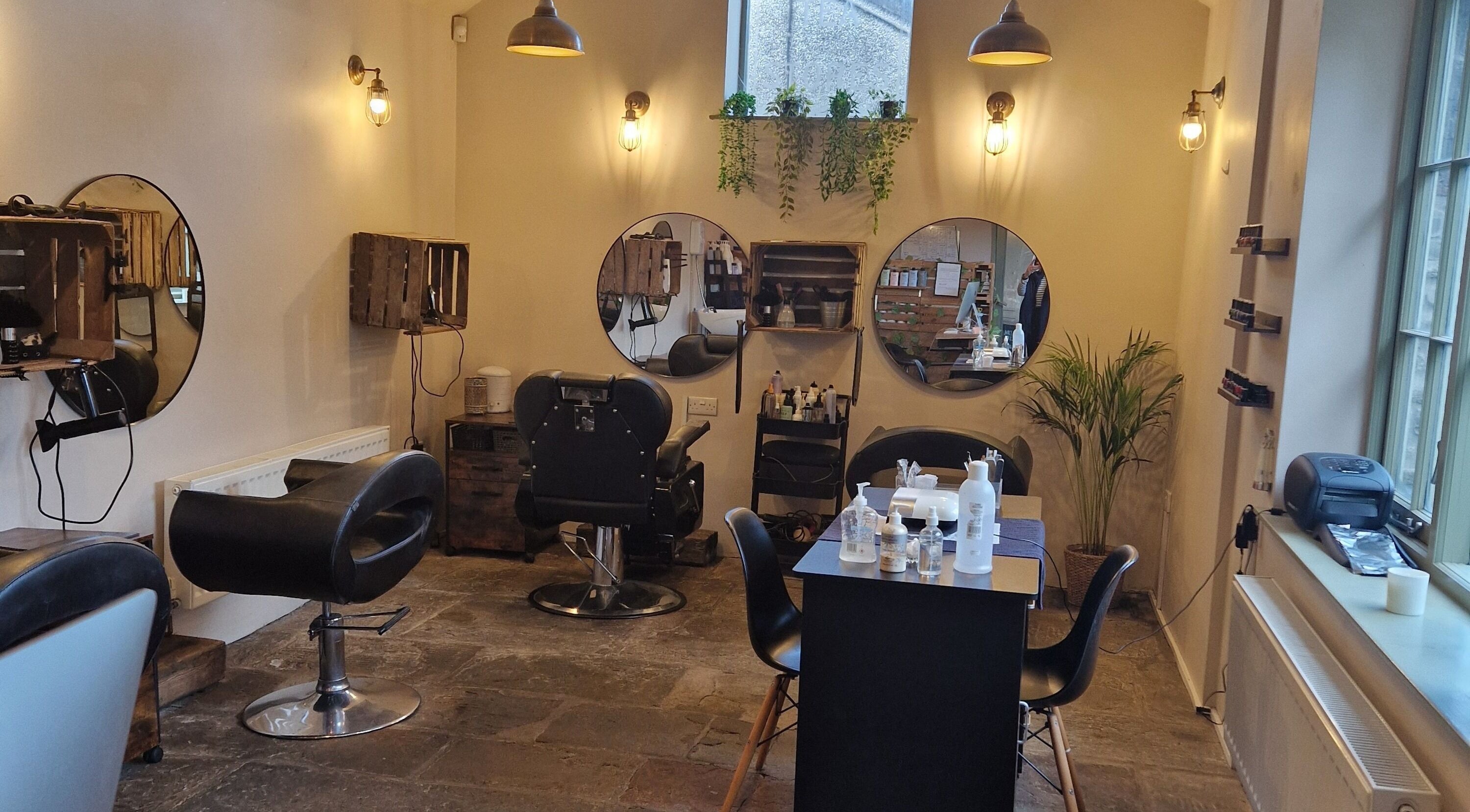 Spacious and elegant interior of Calida Hair & Beauty in Crickhowell, Wales, GB, featuring modern salon chairs.