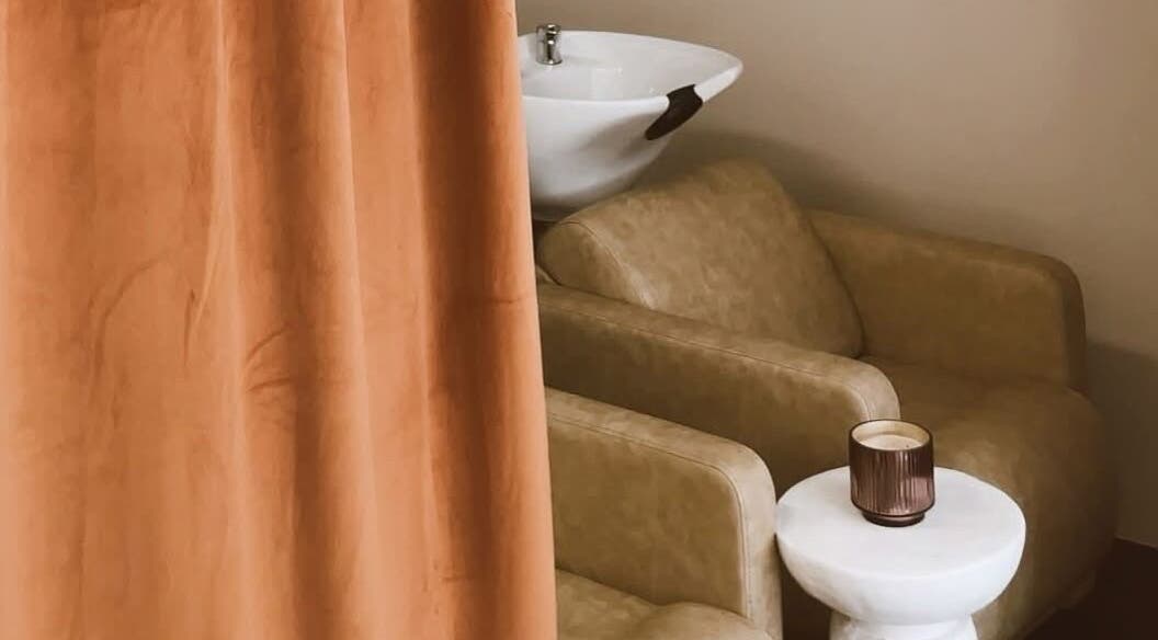Elegant salon seating at Club Sumé - Suman, Calgary, Alberta, CA, with a stylish wash basin.