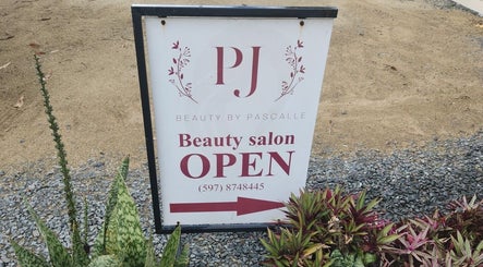Beauty by Pascalle salon open sign surrounded by plants in Paramaribo, Paramaribo, SR.