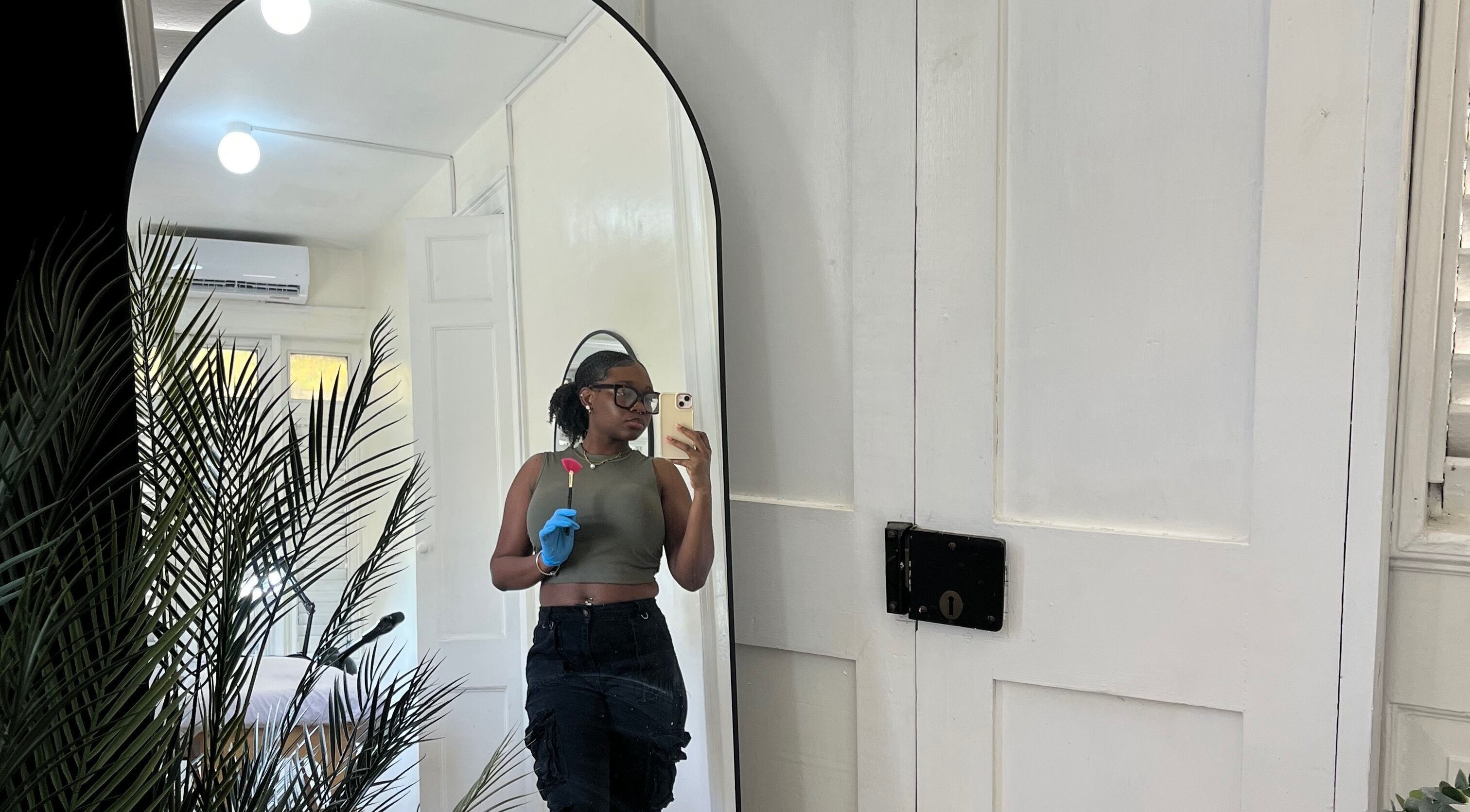 Woman in Waxology Barbados wearing gloves in a serene room at Bridgetown, Saint Michael, BB.