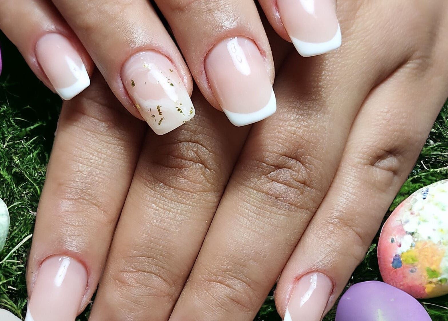 Beautiful manicure with French tips at Dhany Nails, County Clare, County Clare, IE surrounded by colorful decor.