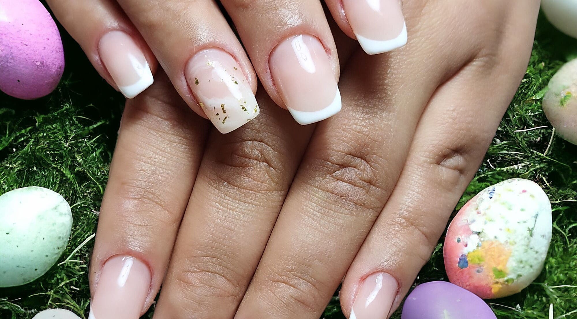 Beautiful manicure with French tips at Dhany Nails, County Clare, County Clare, IE surrounded by colorful decor.