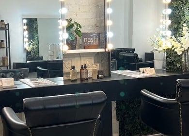 Elegant beauty station at Megy’s Hair Studio in London, England, GB with mirrors and stylish seating.