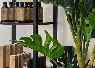Product shelves with lush plants at Megy’s Hair Studio, London, England, GB for a natural ambiance.