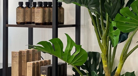 Shelves with Nashi Argan products and lush greenery at Megy’s Hair Studio, London, England, GB.