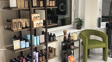 Product display at Megy’s Hair Studio, London, England, GB with a plush green chair.