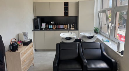 Chic interior of Megy’s Hair Studio in London, England, GB, with modern salon chairs and washing stations.