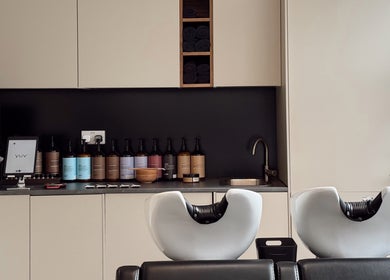 Modern washing station at Megy’s Hair Studio, London, England, GB, featuring sleek sink and premium products.