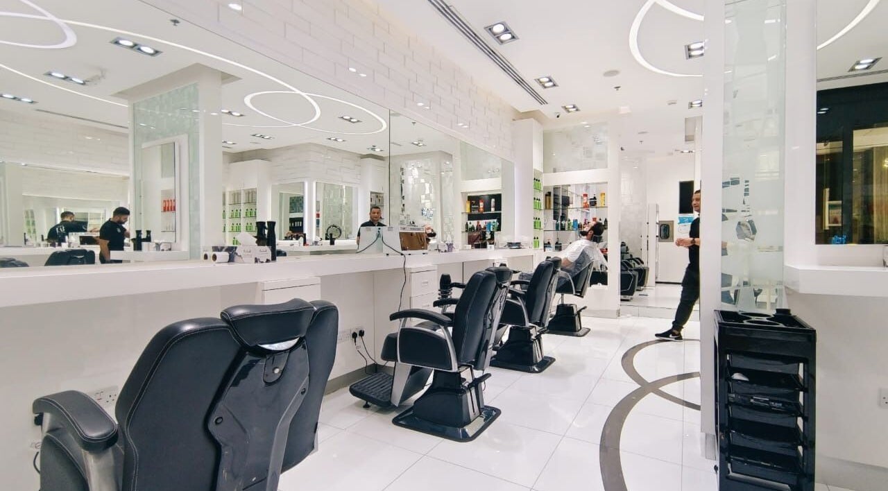 Chic interior of The Lab Gents Salon & Spa - Meadows Town Center, Dubai, AE, featuring sleek styling chairs.