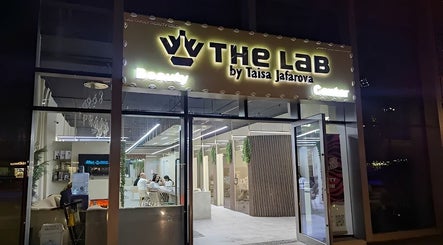Night view of The Lab Gents Salon & Spa at Meadows Town Center, Dubai, AE, showcasing the welcoming entrance.