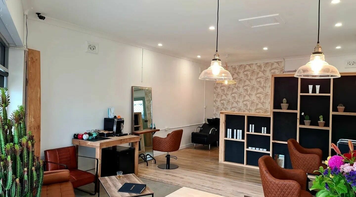 Modern interior of Scott Ya Hair, Long Jetty, New South Wales, AU, showcasing stylish chairs and decor.