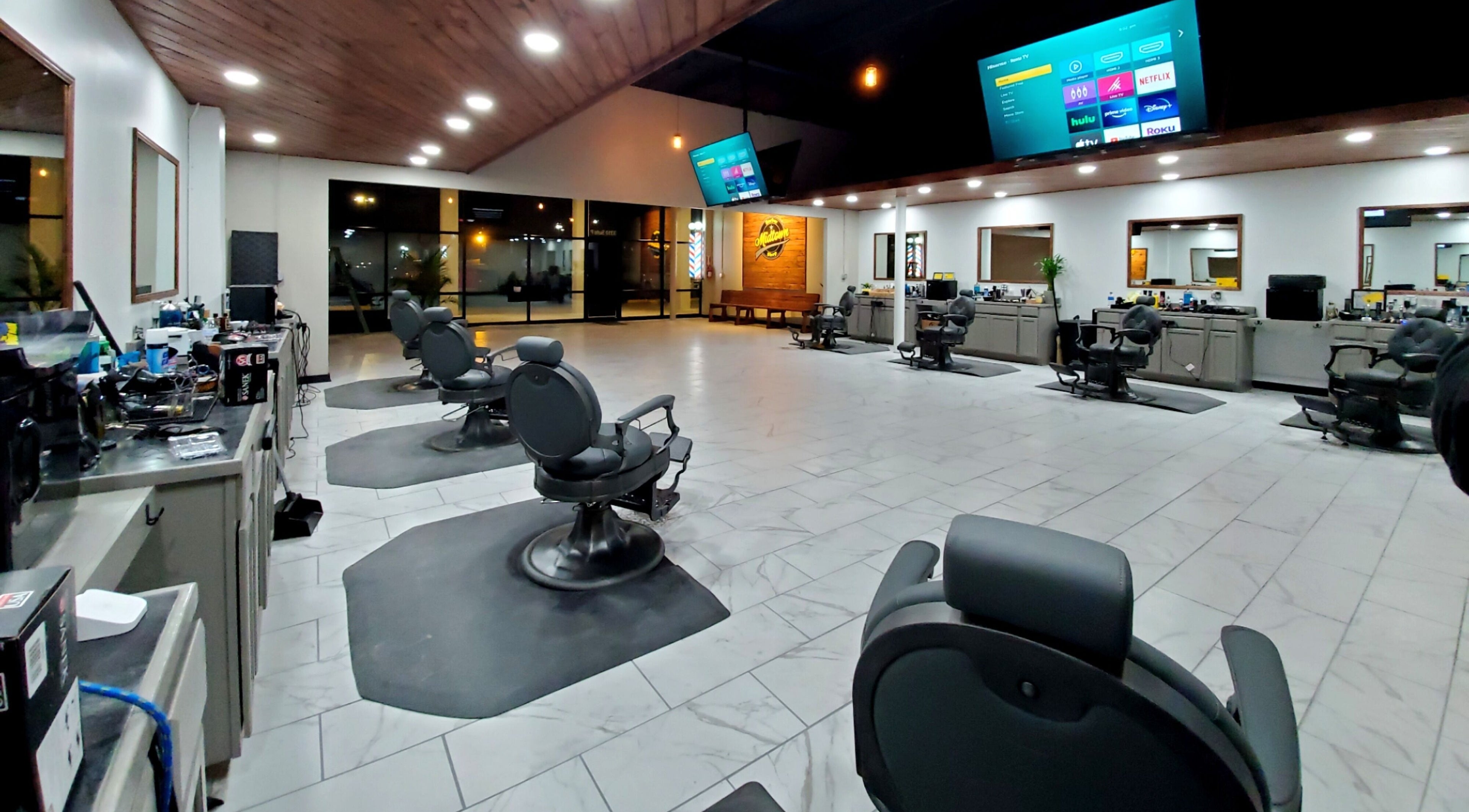 Spacious interior of Midtown Barber Shop in Hot Springs, Arkansas, US with modern barber chairs and stylish decor.