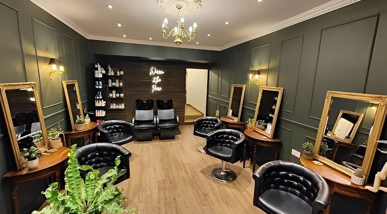 Interior view of Warren & the Hare in Bournemouth, England, GB featuring stylish salon setup with mirrors and chairs.