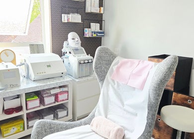 Relaxing treatment room at DERMEDICA Beauty Studio, Hertford, GB, featuring advanced skincare equipment.