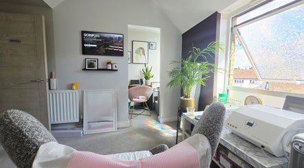Relaxation room at DERMEDICA Beauty Studio, Hertford GB, with plush chair and bright window view.