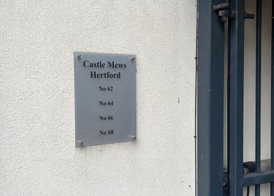 Castle Mews sign near DERMEDICA Beauty Studio, Hertford, GB entrance.