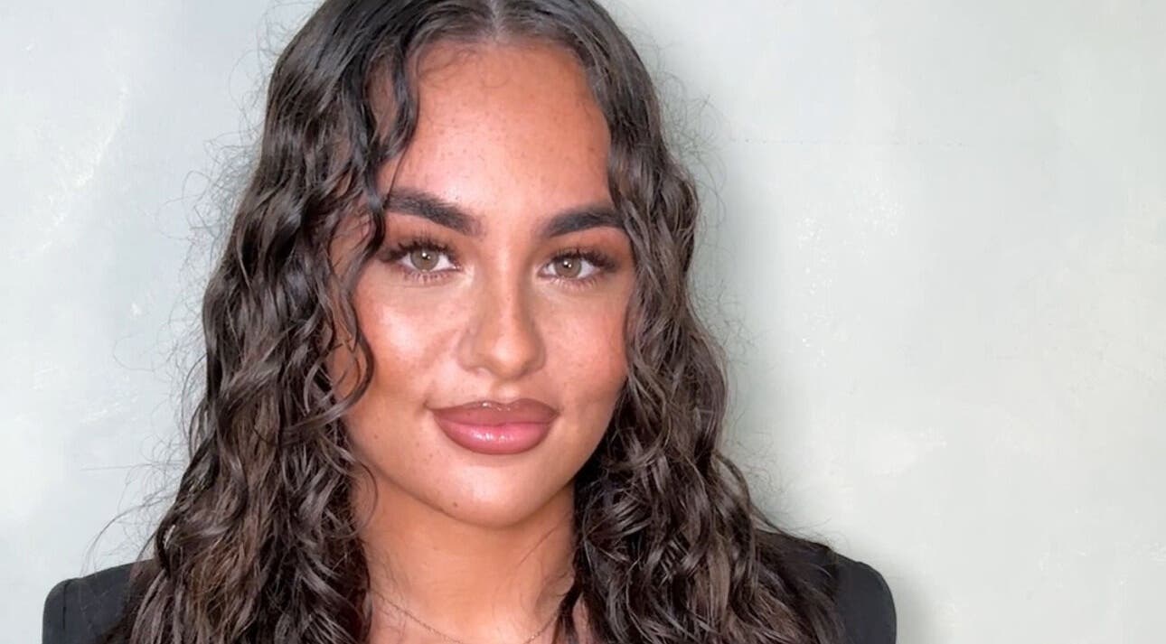 Smiling woman with curly hair at Tal Brea Beauty, Rochdale, England, GB.