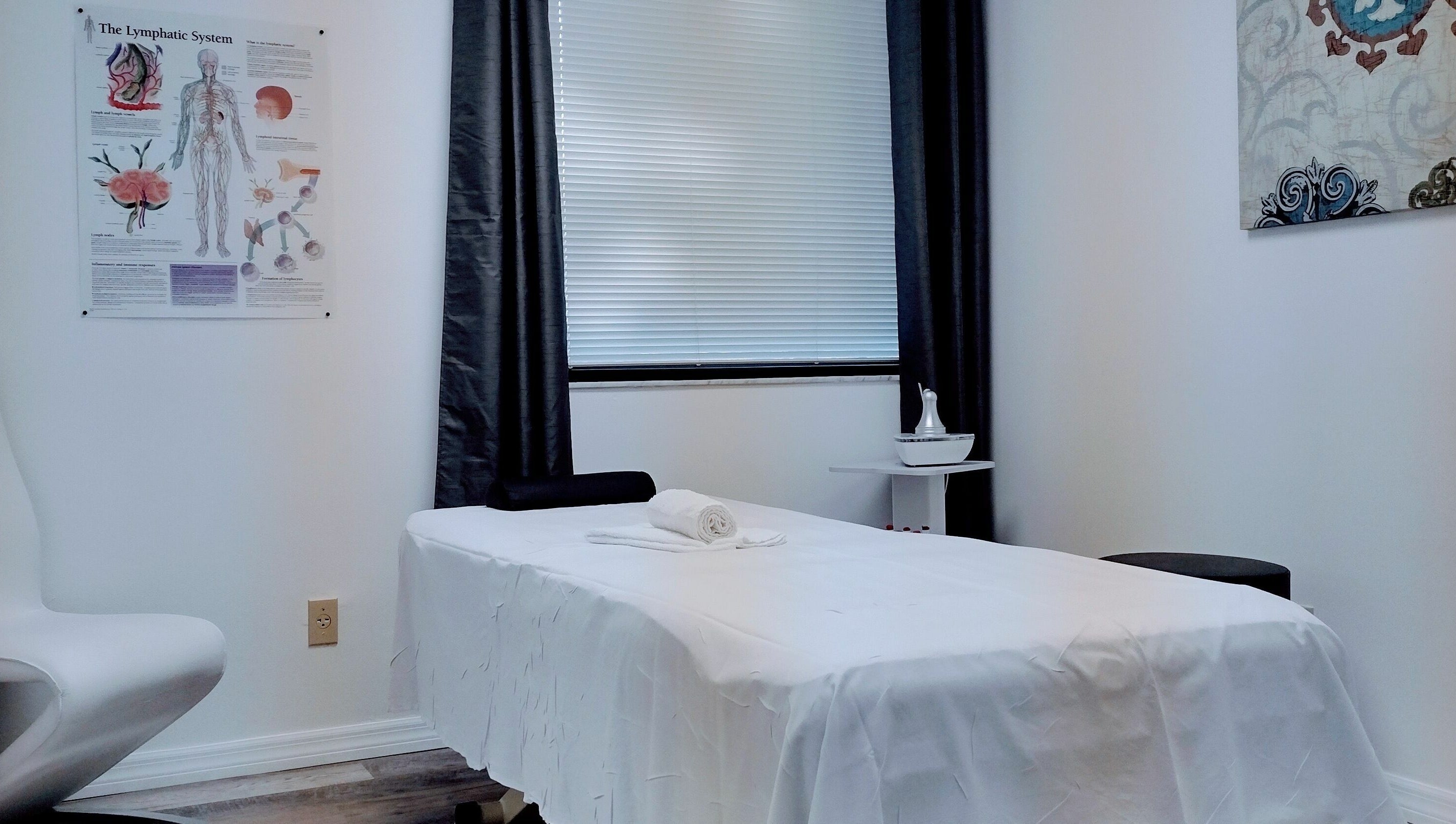 Calming massage room at Shape It Body and Face in Fort Myers, Florida, US with a treatment bed.