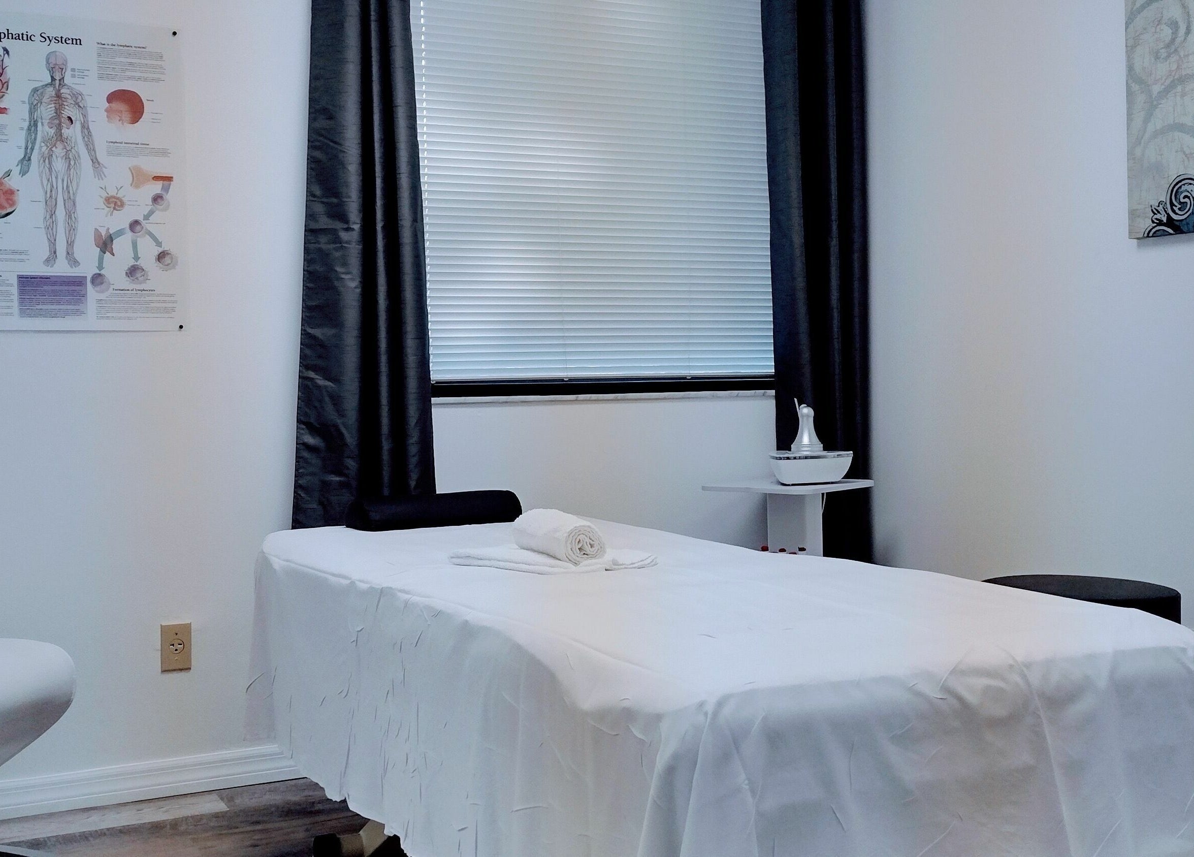 Calming massage room at Shape It Body and Face in Fort Myers, Florida, US with a treatment bed.
