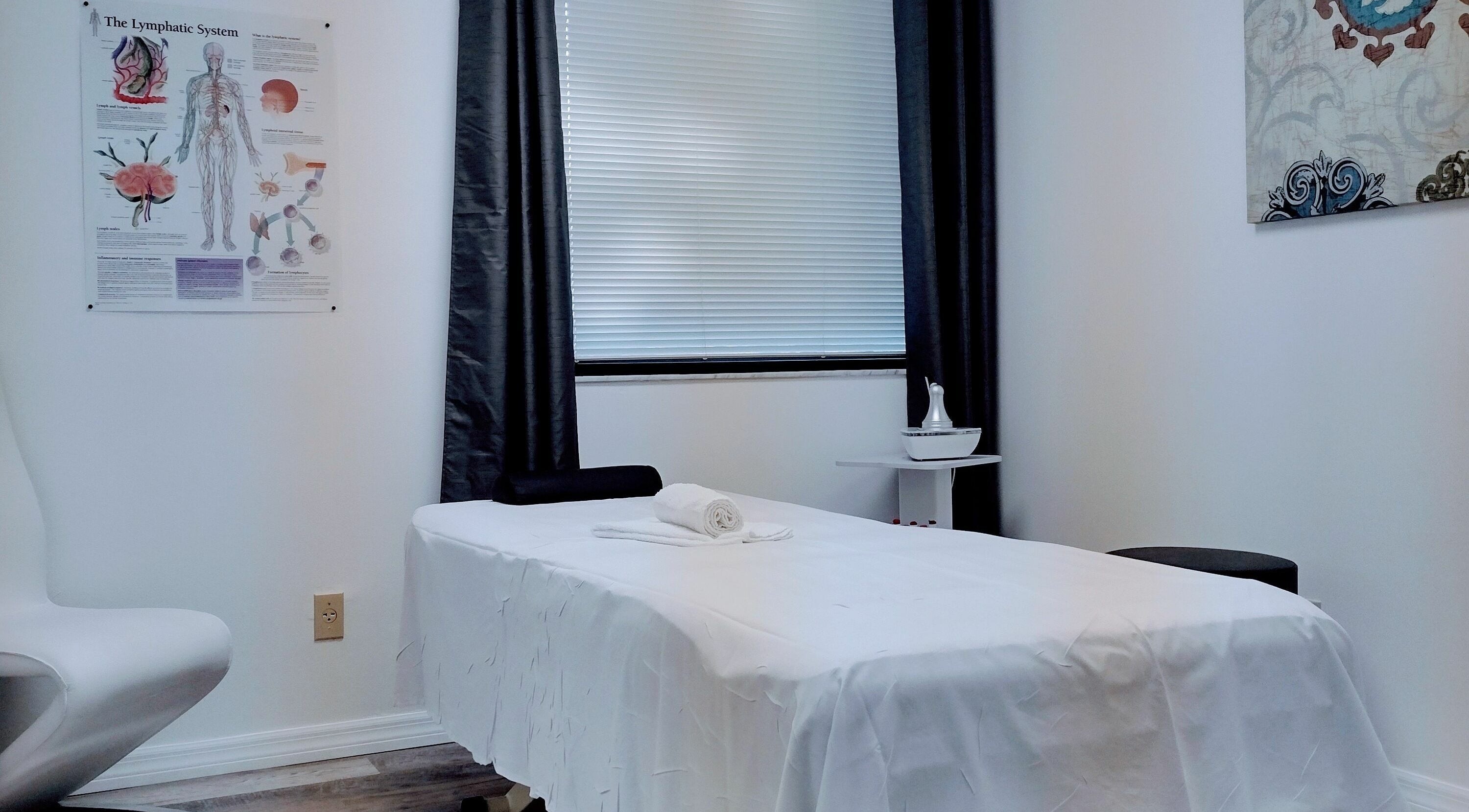 Calming massage room at Shape It Body and Face in Fort Myers, Florida, US with a treatment bed.