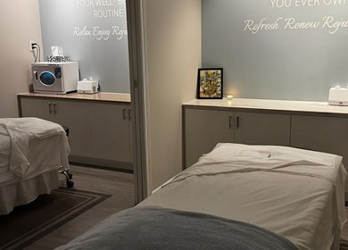 Cozy treatment room at Oakspa Wellness Inc., Markham, Ontario, CA, featuring two massage tables and elegant decor.