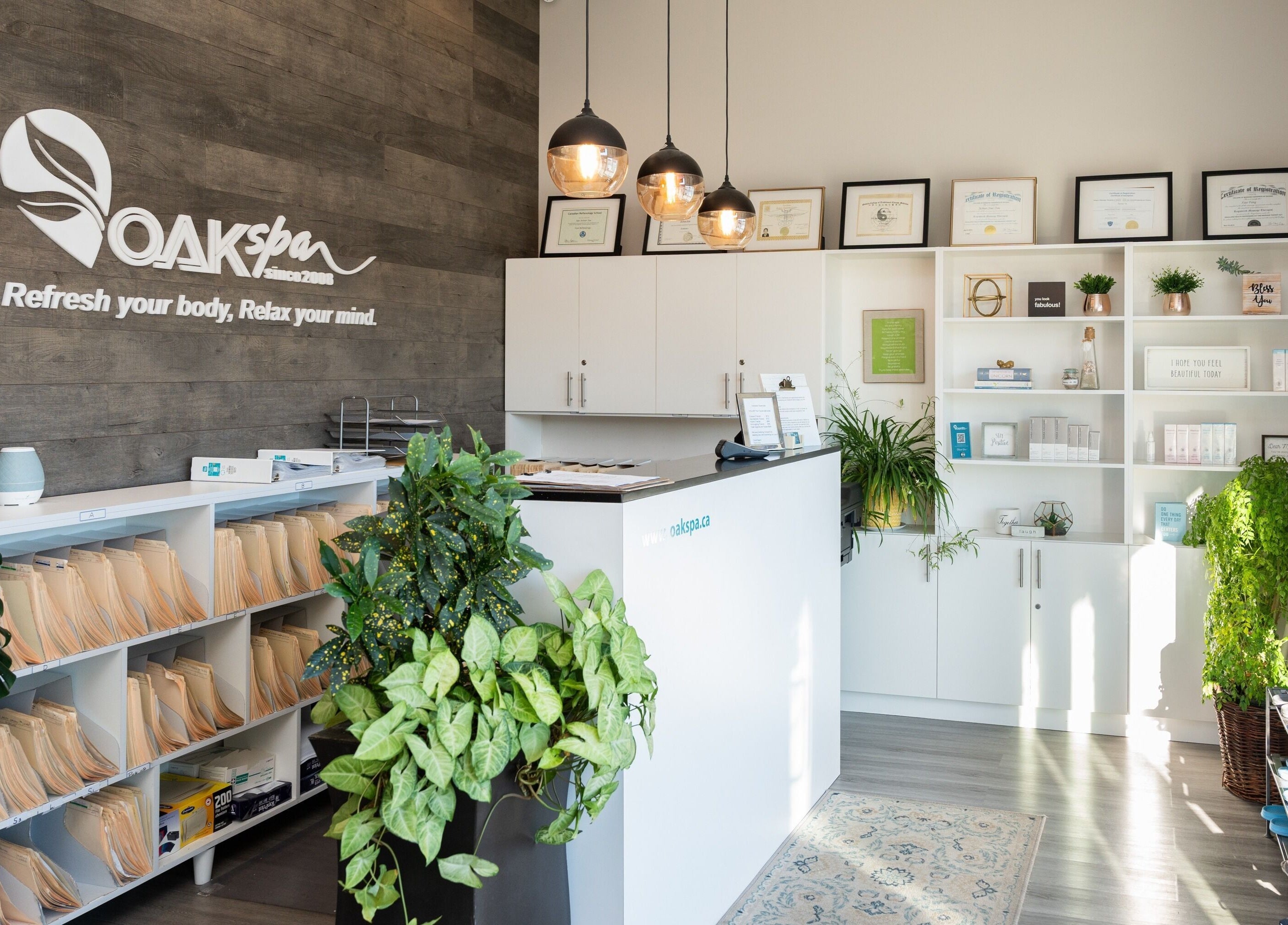 Reception area at Oakspa Wellness Inc. in Markham, Ontario, CA, featuring modern decor and lush plants.