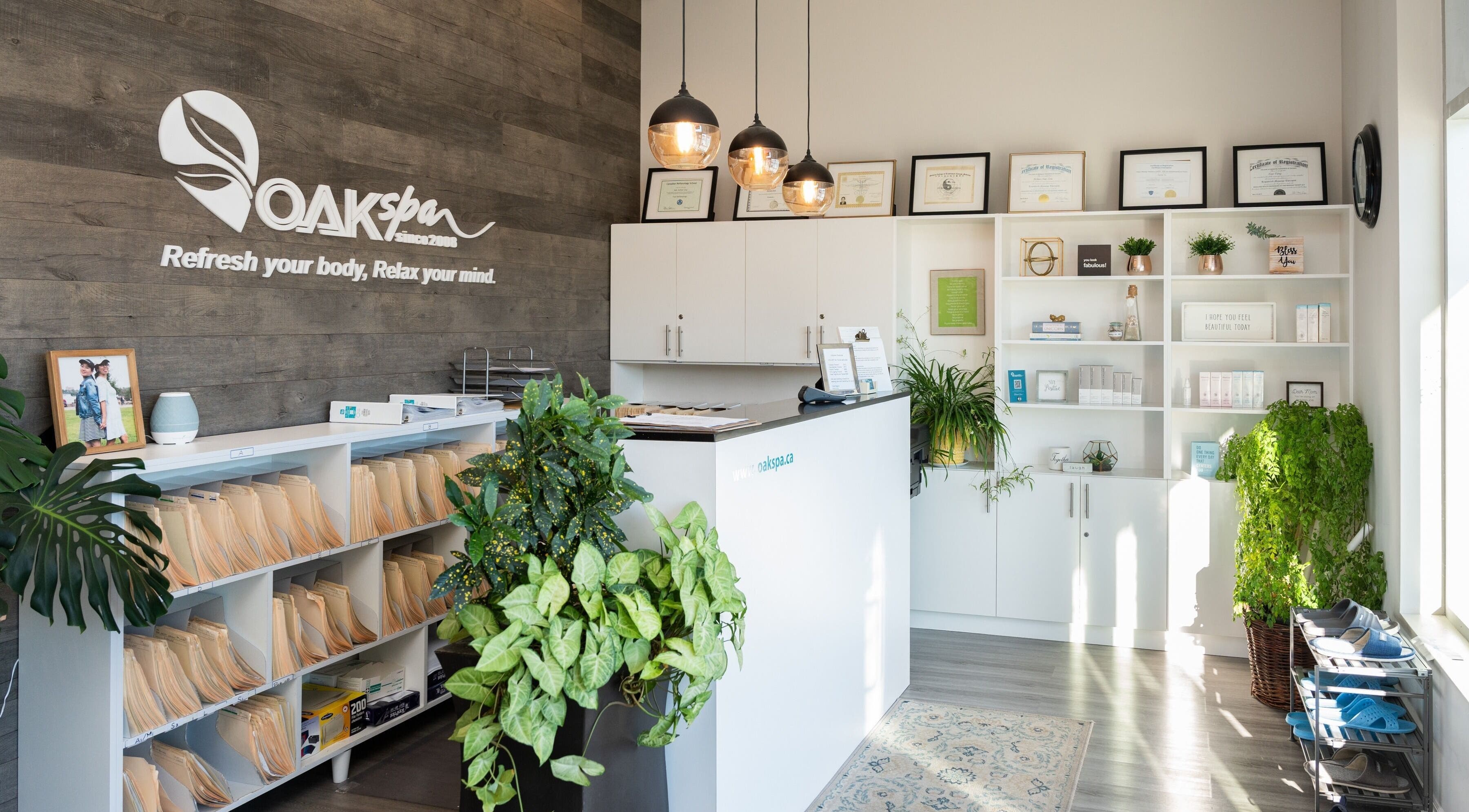 Reception area at Oakspa Wellness Inc. in Markham, Ontario, CA, featuring modern decor and lush plants.