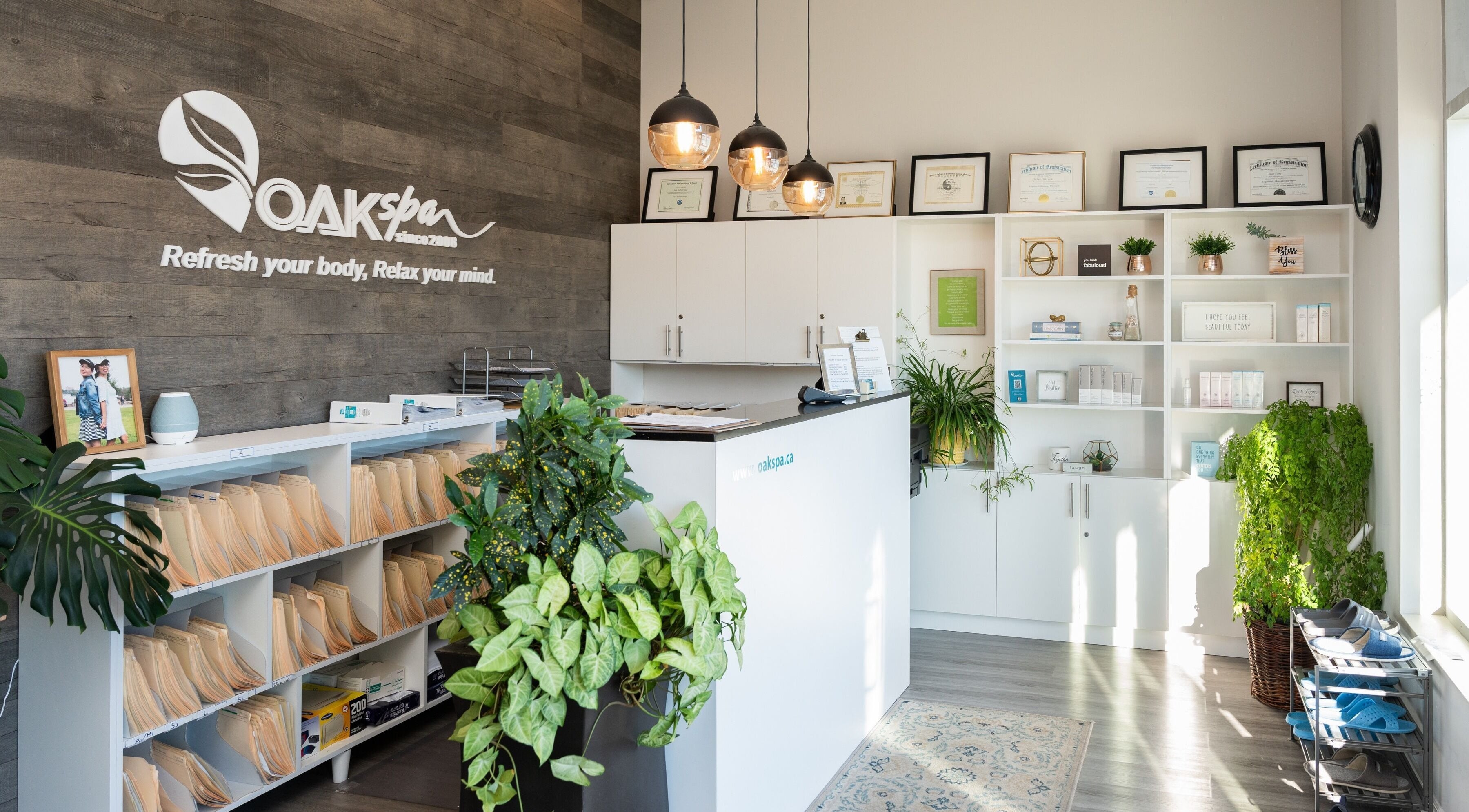 Reception area at Oakspa Wellness Inc. in Markham, Ontario, CA, featuring modern decor and lush plants.