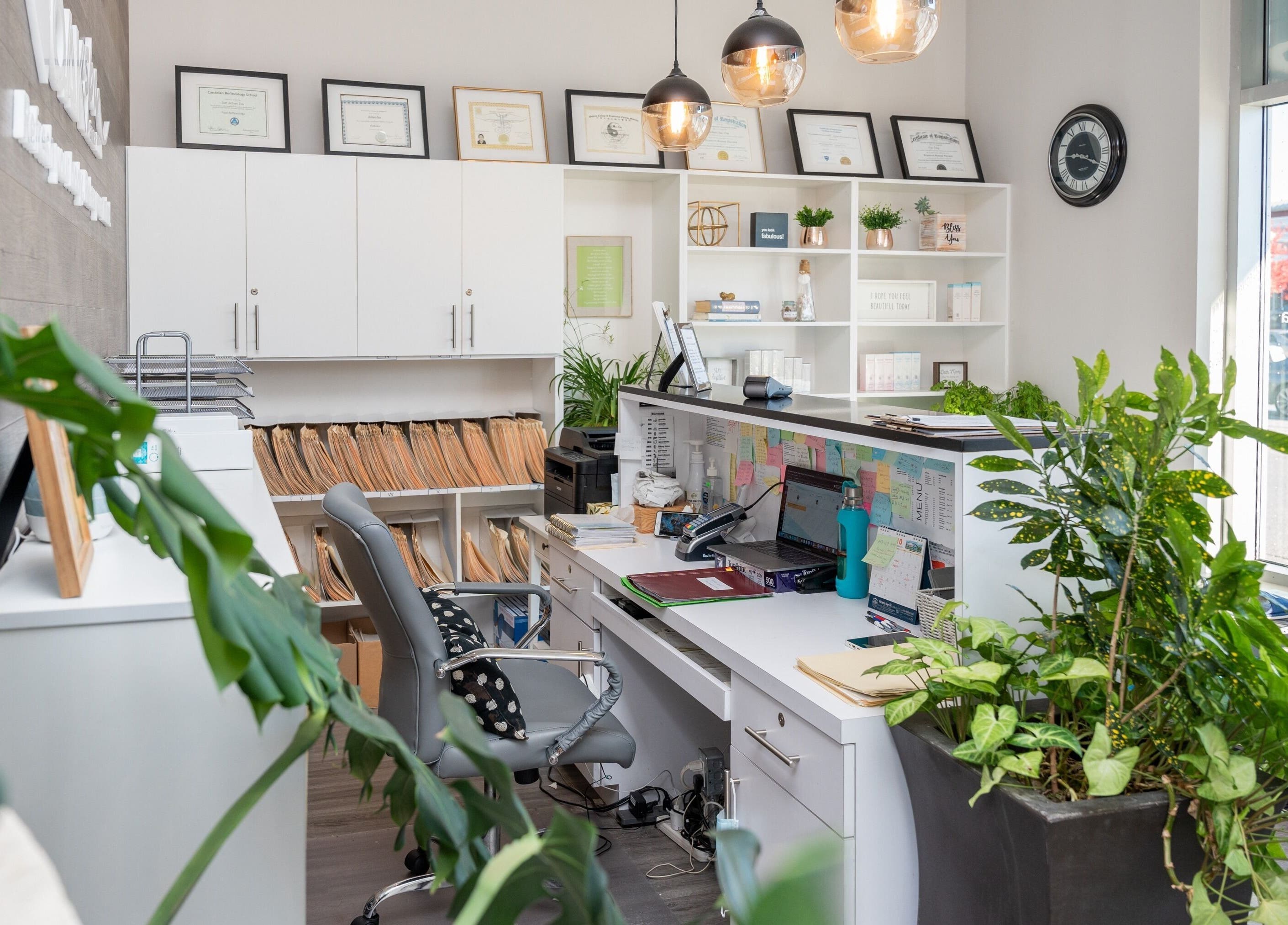Reception area at Oakspa Wellness Inc., Markham, Ontario, CA featuring modern decor and lush greenery.