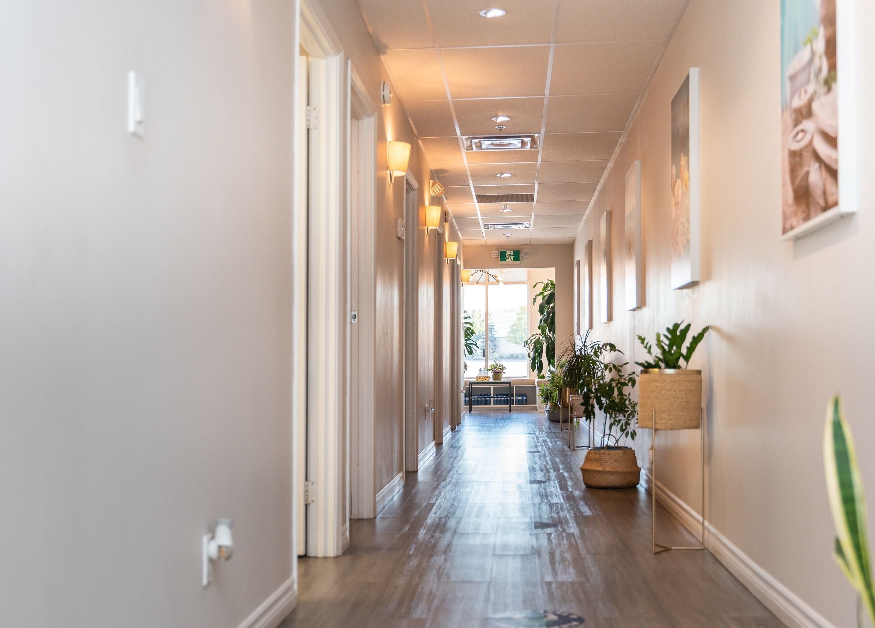 Bright hallway at Oakspa Wellness Inc., Markham, Ontario, CA, with plants and cozy lighting.