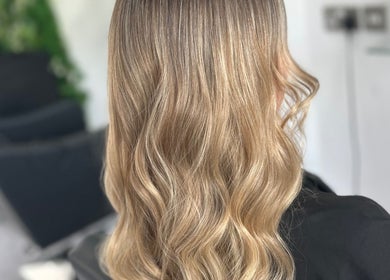 Blonde wavy hairstyle at SLS Hair and Beauty Chessington, England, GB.
