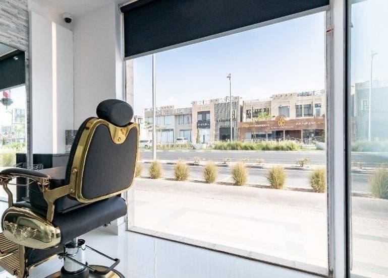 Luxury barber chair with street view at Kenchie Gents Salon Al Nahda, Dubai, AE, reflecting modern style.